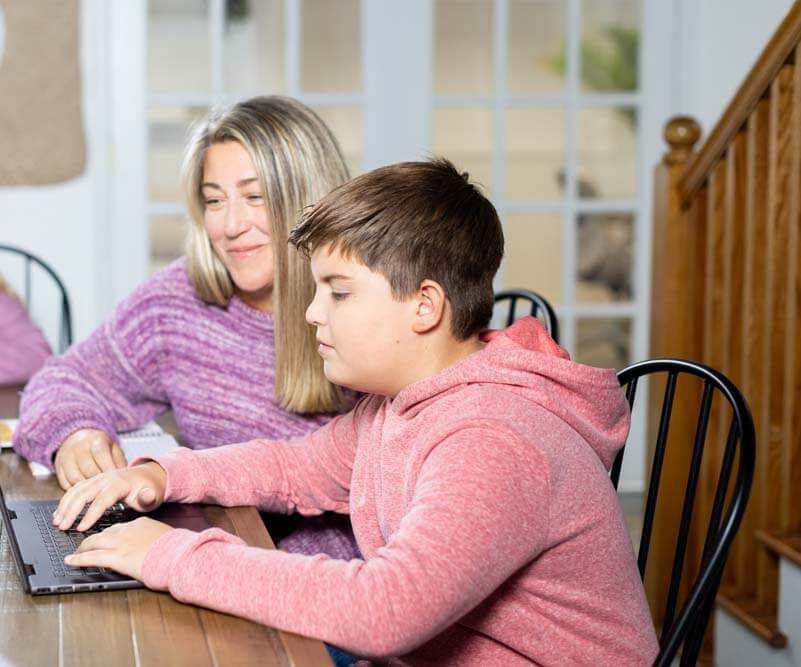mom and son on the computer while doing a Lexercise therapy sesson