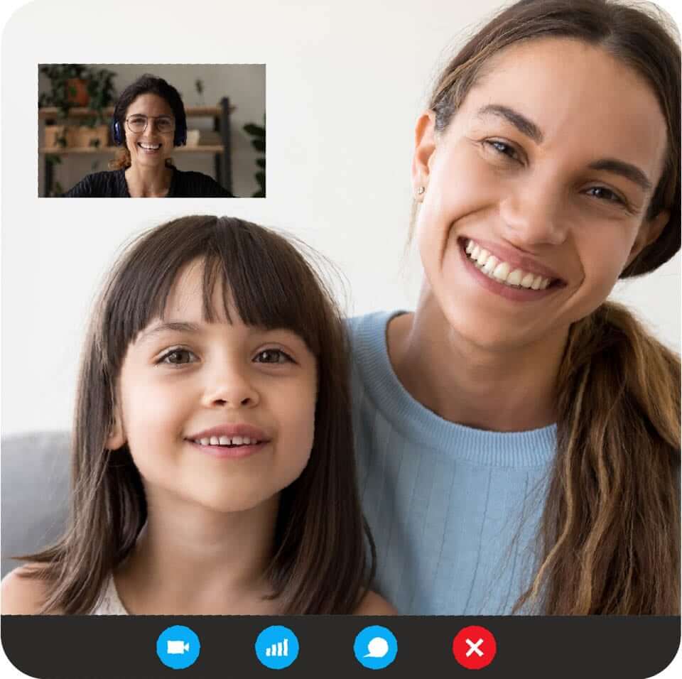 Mother and daughter smiling with a small screen above them showing a tutor who is also smiling