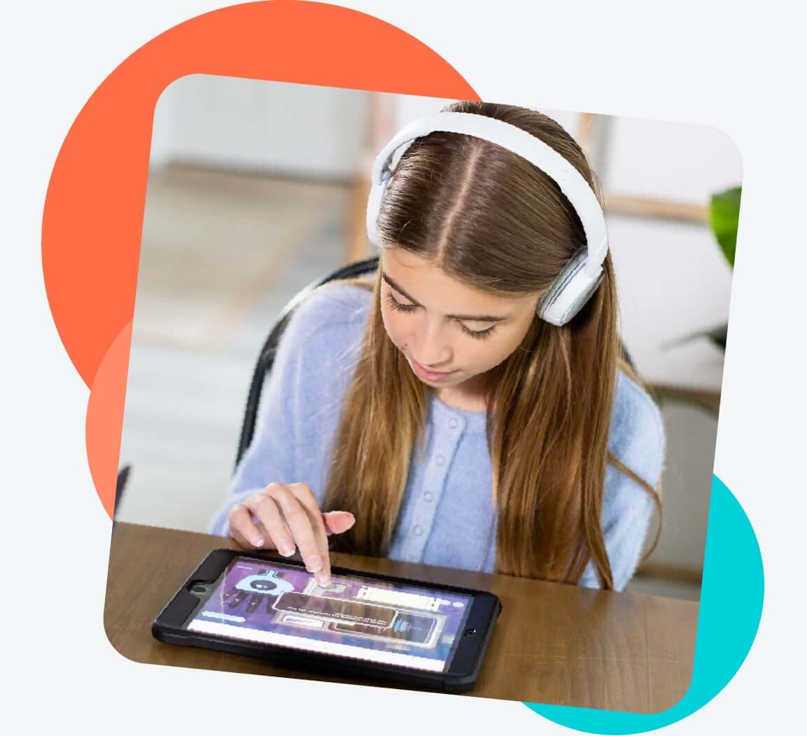 Girl wearing headphones plays an educational game on her iPad
